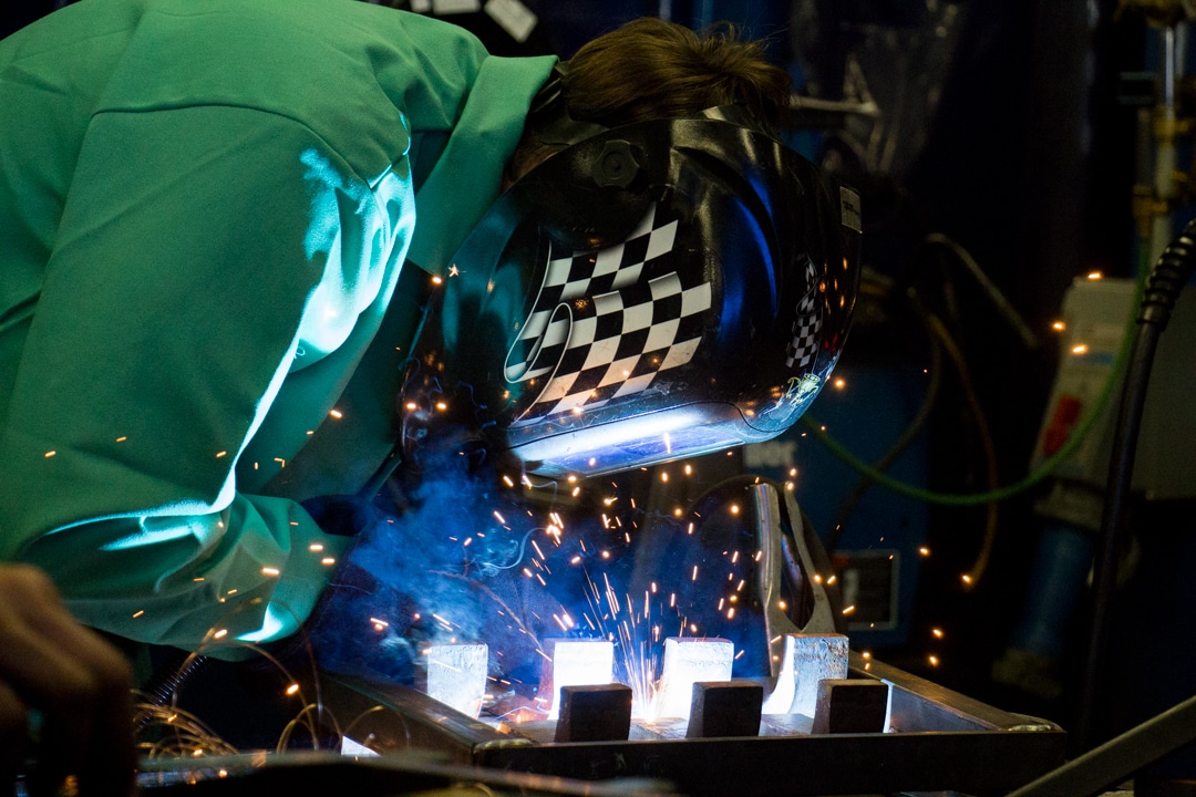 Male Welding student welding steel at Junkyard Challenge