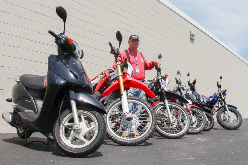 Motorcycle safety instructor Kim Rudat with a display of bikes