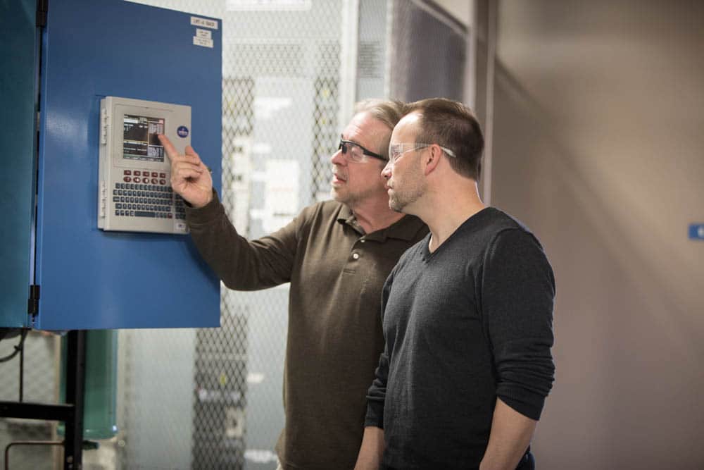 Two men looking at HVAC machine at Moraine Park