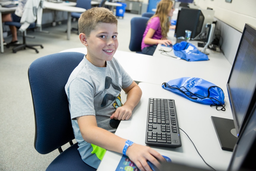 Young boy working on computer at Tech Knowledge College event