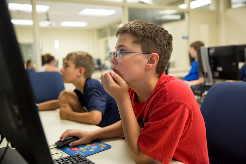 Male 8th grader working on computer
