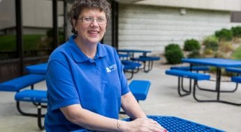 Moraine Park staff at blue picnic table outside