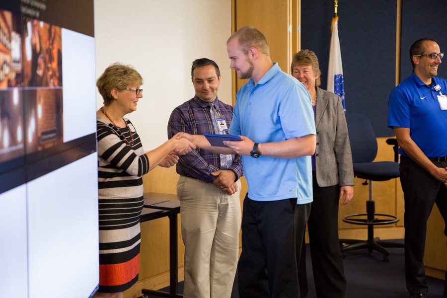 Moraine Park Business Instructor Ann Lemke shaking hands wtih students at TACT 3 summer cohort ceremony