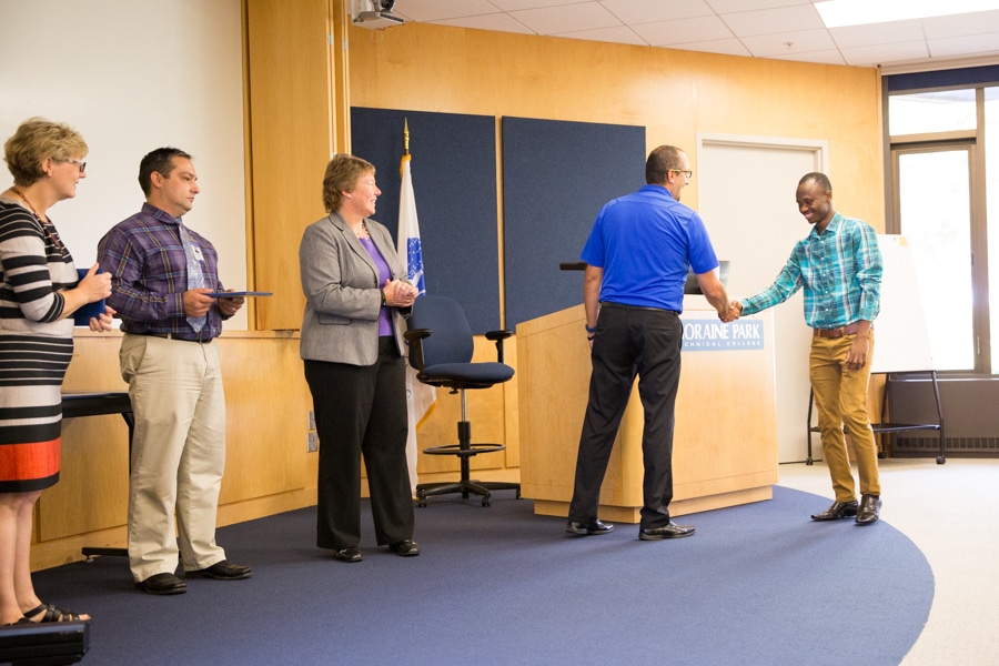 Moraine Park Business Instructor Jeff Stueber shaking hands wtih students at TACT 3 summer cohort ceremony