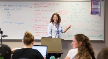 Moraine Park Instructor Emily Hayes teaching students notes on white board