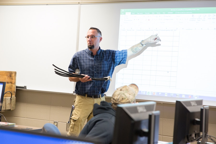 instructor mark wamsley points to screen in front of class