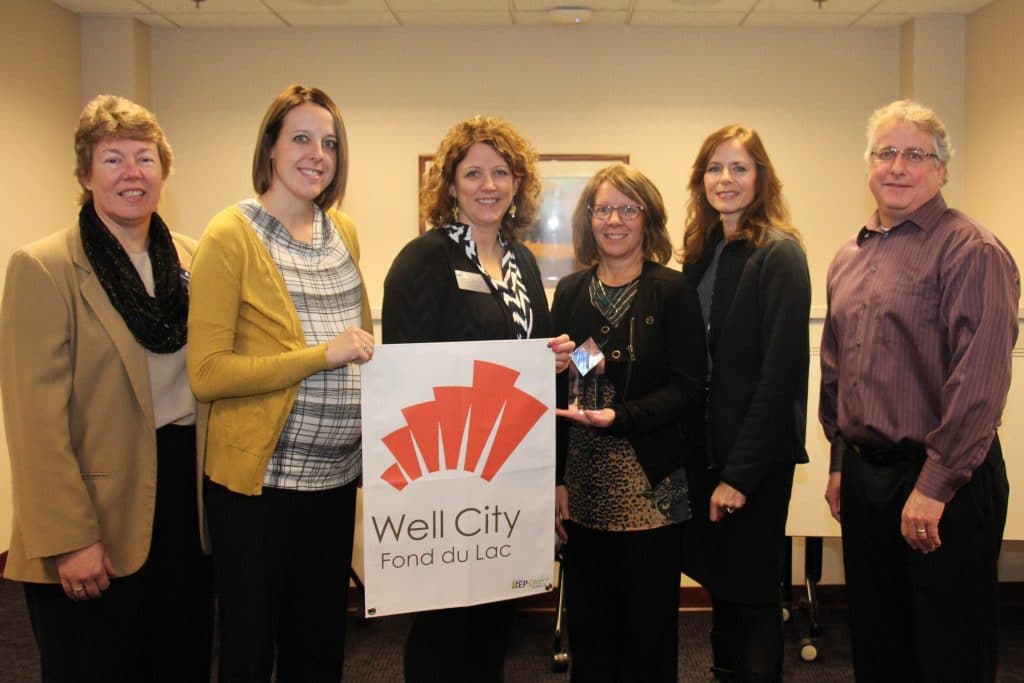 Moraine Park Technical College has achieved Well Workplace designation from the Wellness Council of America. Shown here with Moraine Park’s wellness recognition award are Bonnie Baerwald, President; Krista Mallas, Human Resources Assistant; Kim Braatz, Careers Instructor; Lori Schrage, Benefits Coordinator; Kathy Broske, VP-Human Resources; and Greg Kilgas, Compensation & Benefits Manager.
