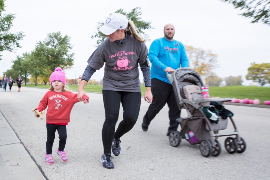 family walks with kids and stroller during moraine park great pink pumpkin event