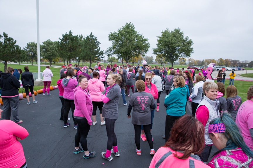 group gathers in parking lot before pink pumpkin walk
