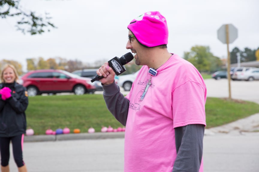 instructor speaks into microphone during pink pumpkin walk