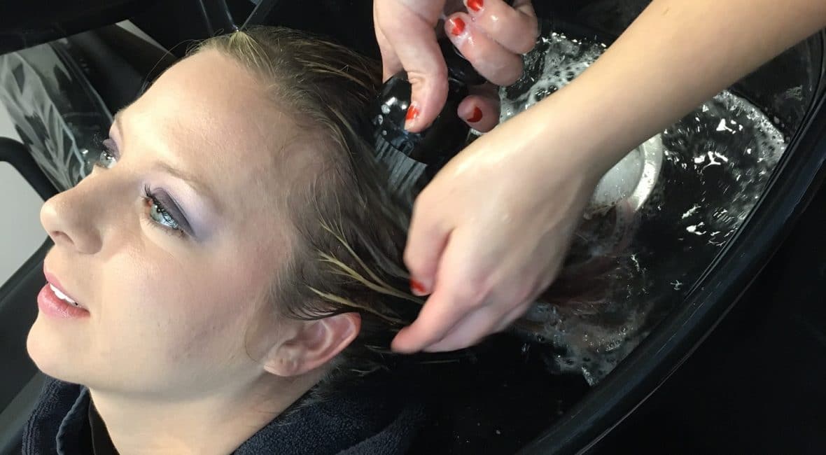 Moraine Park Social Media & Advertising Manager, Carol Moore getting hair washed in Cosmetology