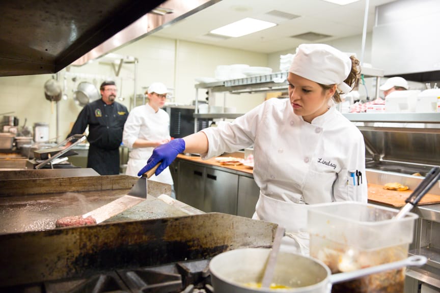 Moraine Park culinary student preparing food in kitchen