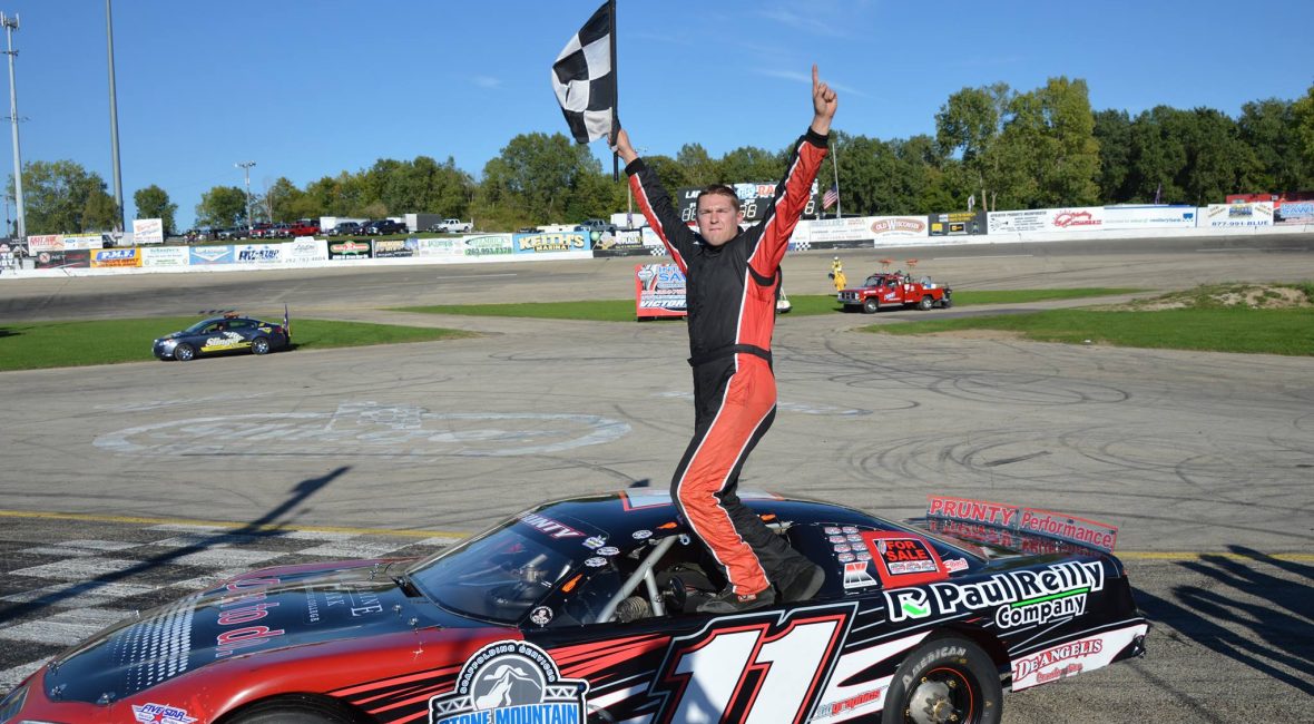 Kulwicki race car driver holding winning flag
