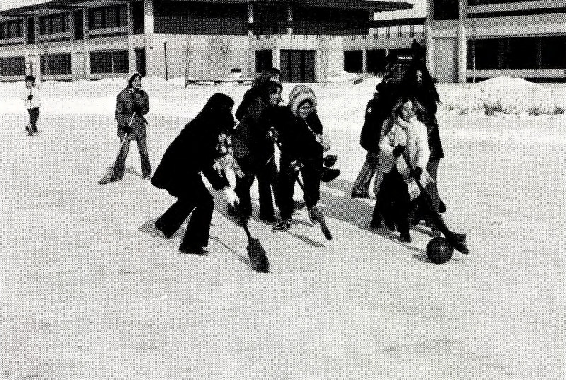 Vintage black & white photo of Moraine Park students playing broom hockey