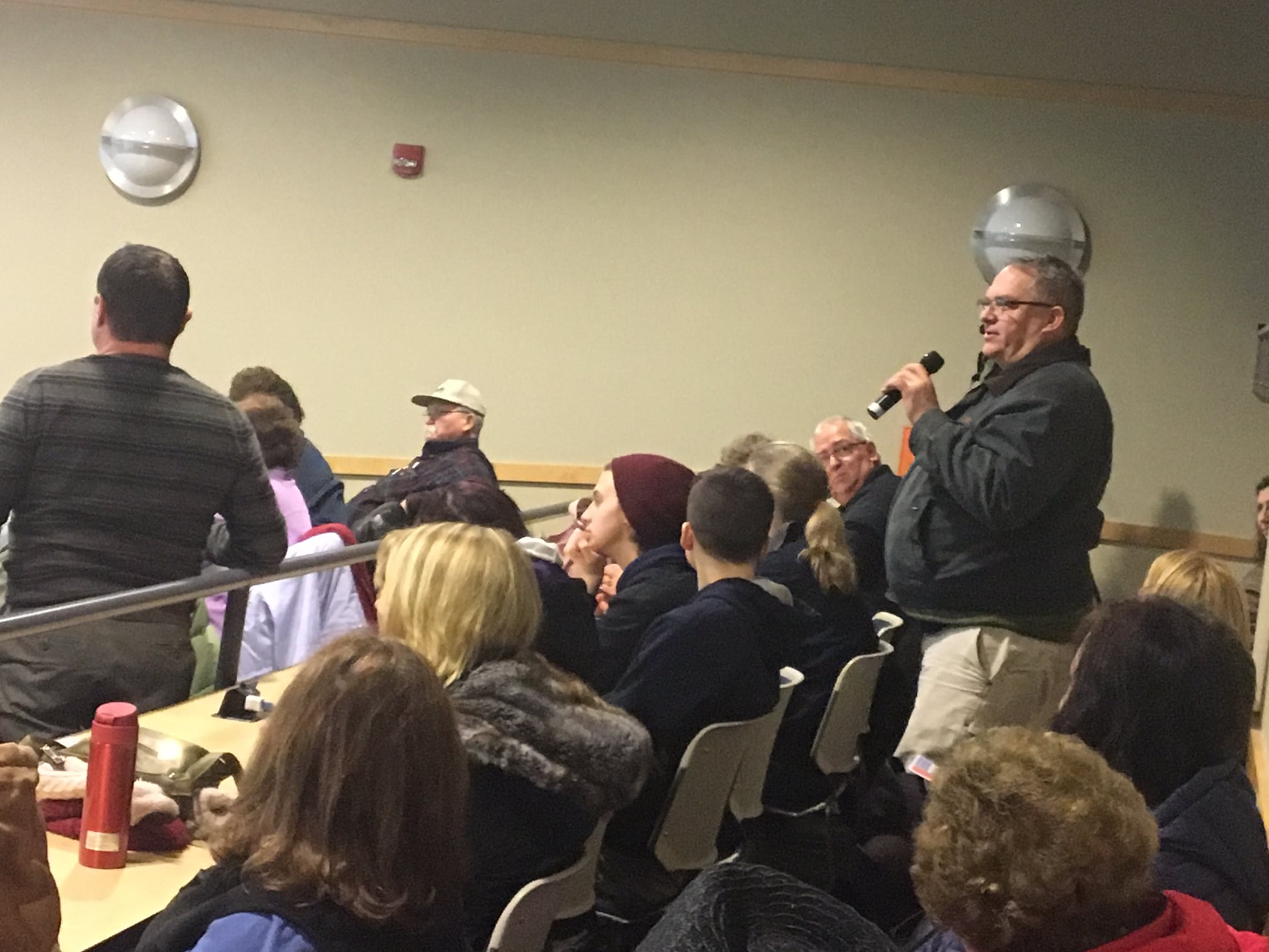 Man speaks wtih microphone at Heroin information session