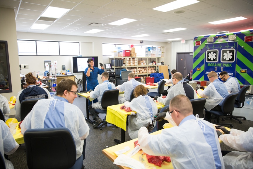 classroom of EMT students dissect pig parts at moraine park