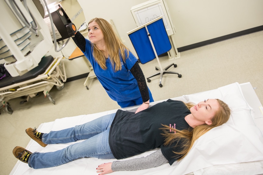 Moraine Park Radiography student simulates procedure with female student on table