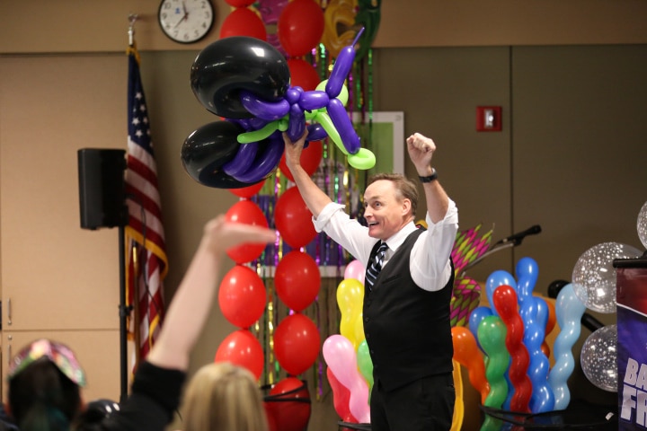 john cassidy holds up arms during moraine park balloon show