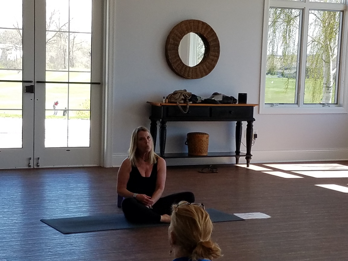 yoga instructor talks to crowd