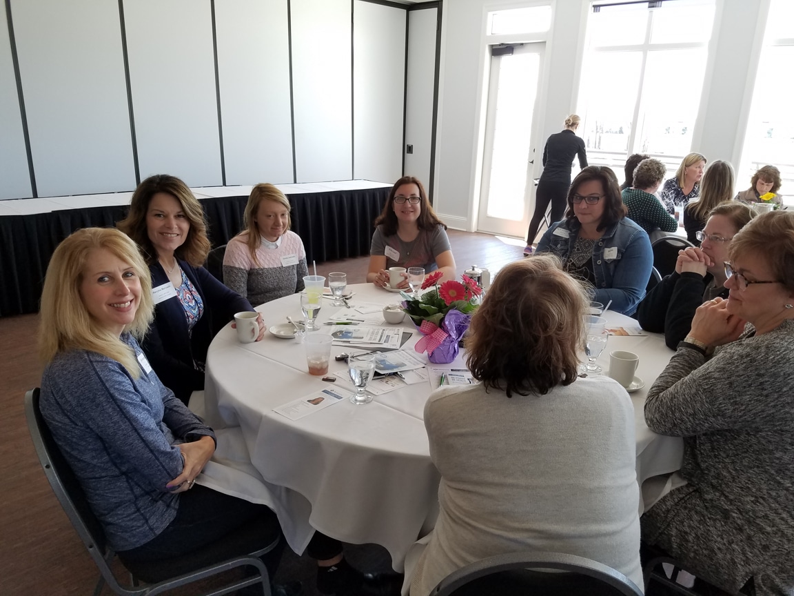 attendees smile at mptc Wisconsin Women in Higher Education Leadership workshop