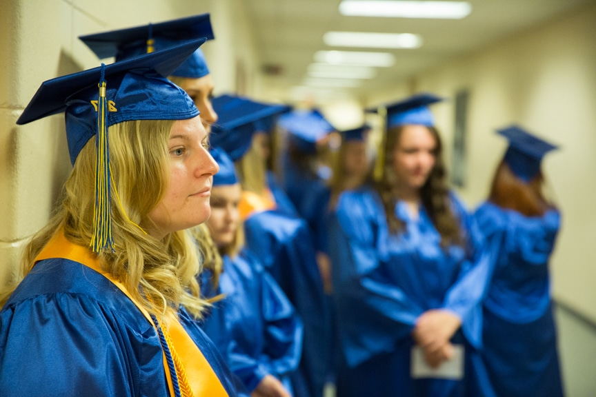 Female graduate waits in hallway prior to ceremony