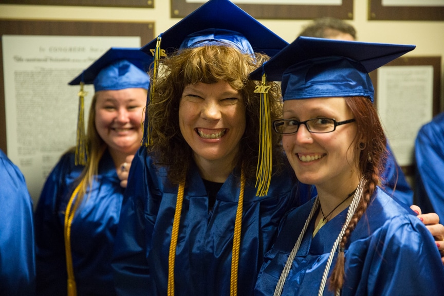 Two female graduates smile
