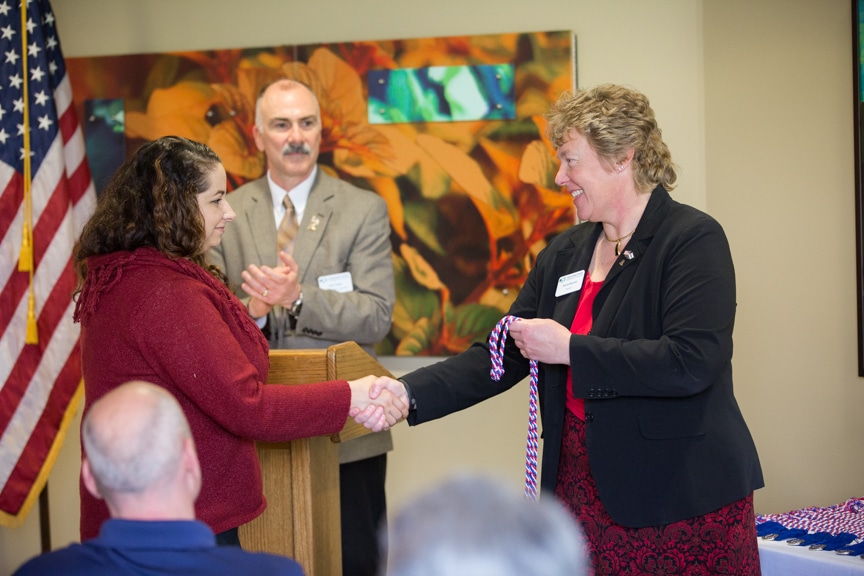 Moraine Park president Bonnie Baerwald shaking hands of female veteran