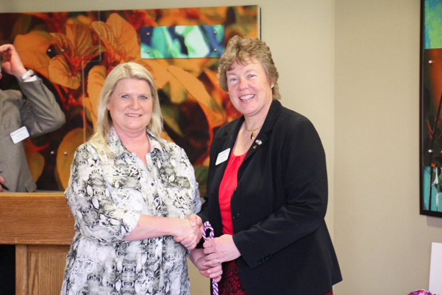 Moraine Park president Bonnie Baerwald shaking hands of veteran