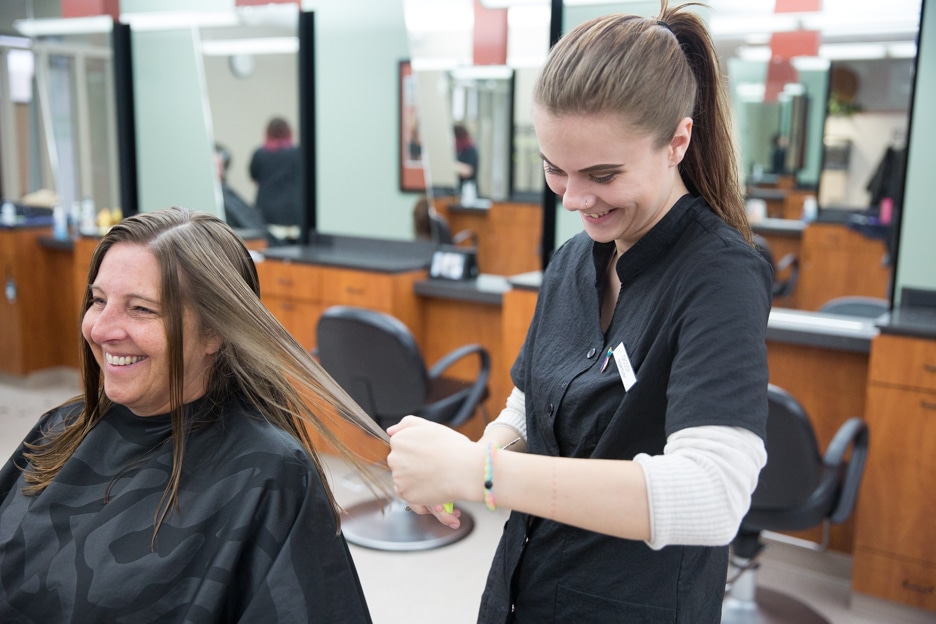Moraine Park student cutting customers hair