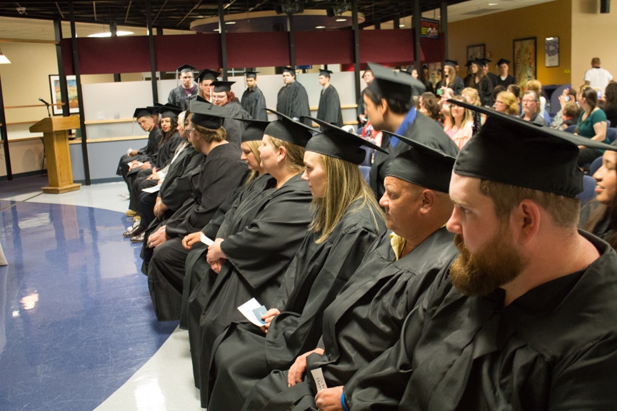 Students march in and sit down in rows at Moraine Park GED-HSED graduation ceremony