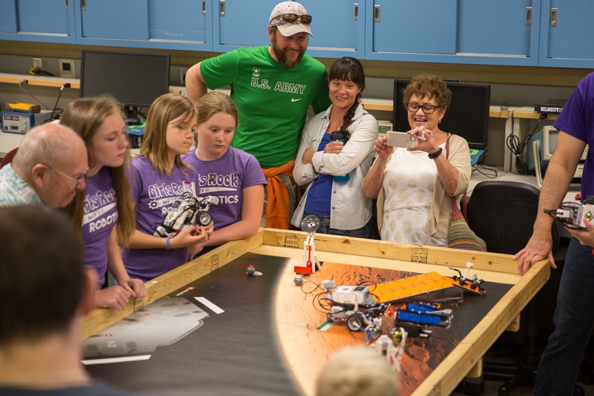 Family members watch as girls display lego robotics projects at Moraine Park summer camp