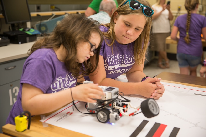 Two girls work on Lego robot during Moraine Park summer camp