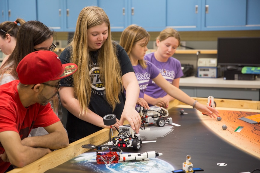 Family members watch as girls display lego robotics projects at Moraine Park summer camp