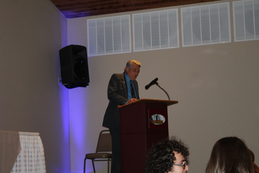 Dr. Stan Cram speaking from podium at student awards banquet