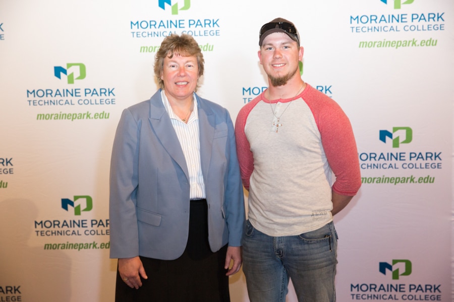 Moraine Park president Bonnie Baerwald and male student at Student Awards Banquet