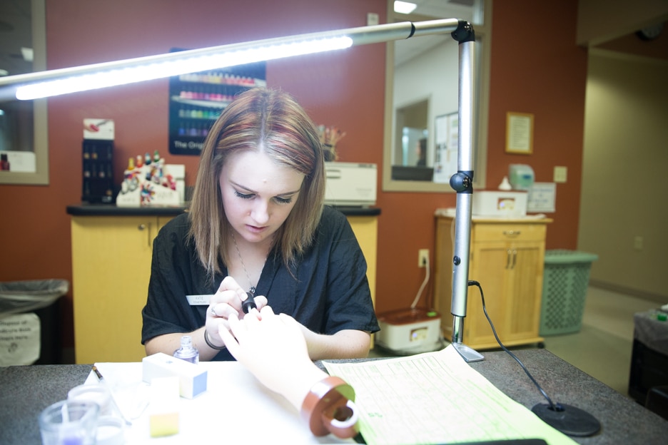 Cosmetology student works on manicure at Moraine Park