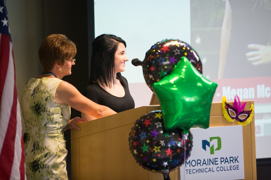Student speaks from podium at Moraine Park fashion show