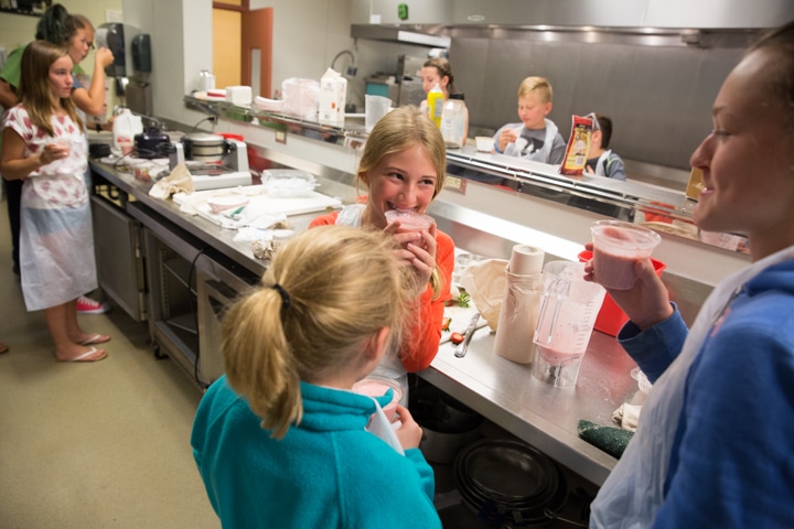 Girls take drink of smoothies during culinary activity at Moraine Park TKC