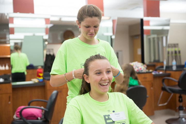 Girls style hair during Moraine Park Tech Knowledge College
