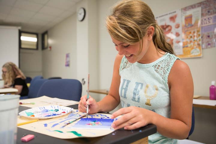 Girl works on painting project at Moraine Park Tech Knowledge College