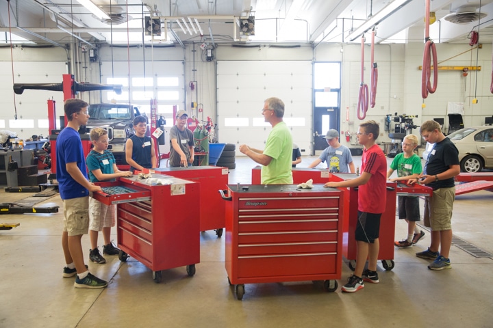 Students gather around tool boxes in automotive lab at Moraine Park Tech Knowledge College