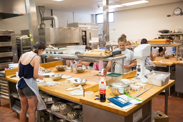 Students work in kitchen during Moraine Park Tech Knowledge College culinary activity