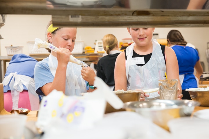 Girls work on icing project during Moraine Park TKC