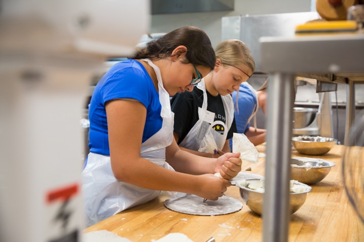 Girls work on icing project during Moraine Park TKC