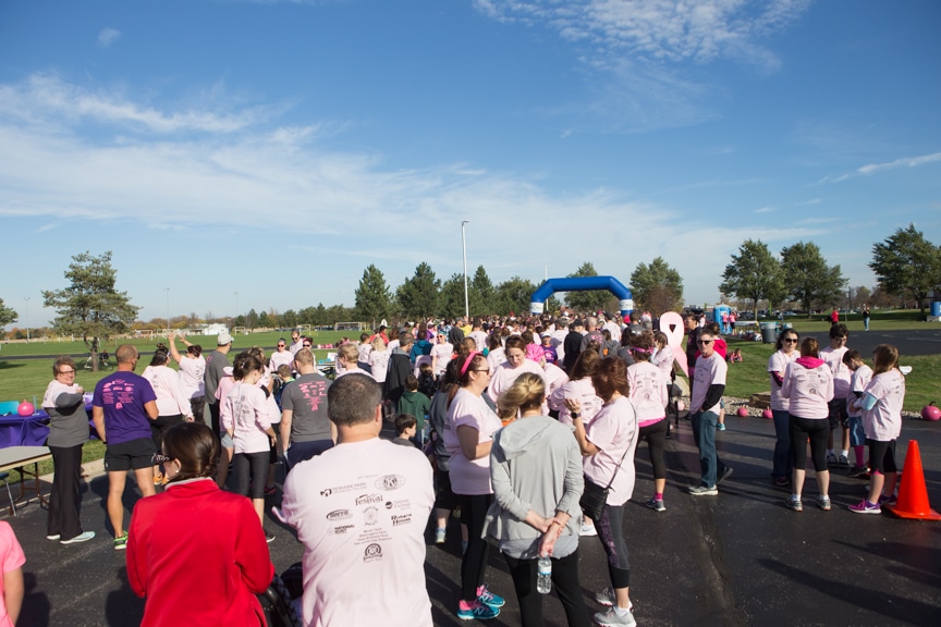large crowd gathers waiting for start of pink pumpkin race