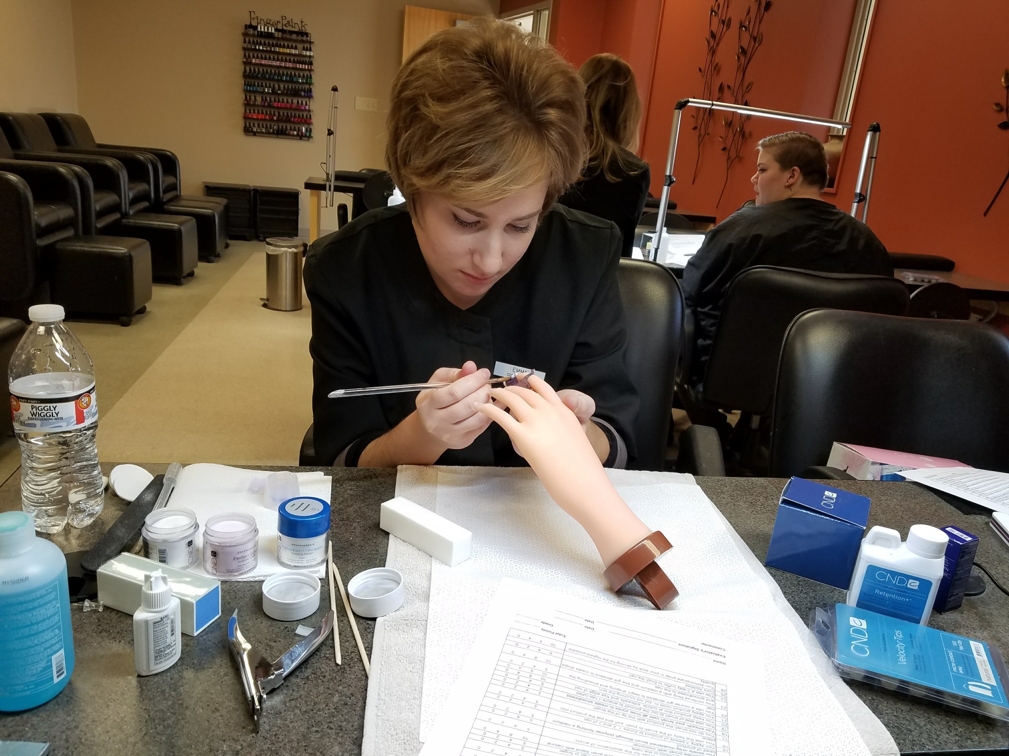 Cosmetology Student practicing artifical nails.