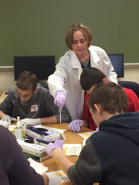 instructor helps students do lab test 