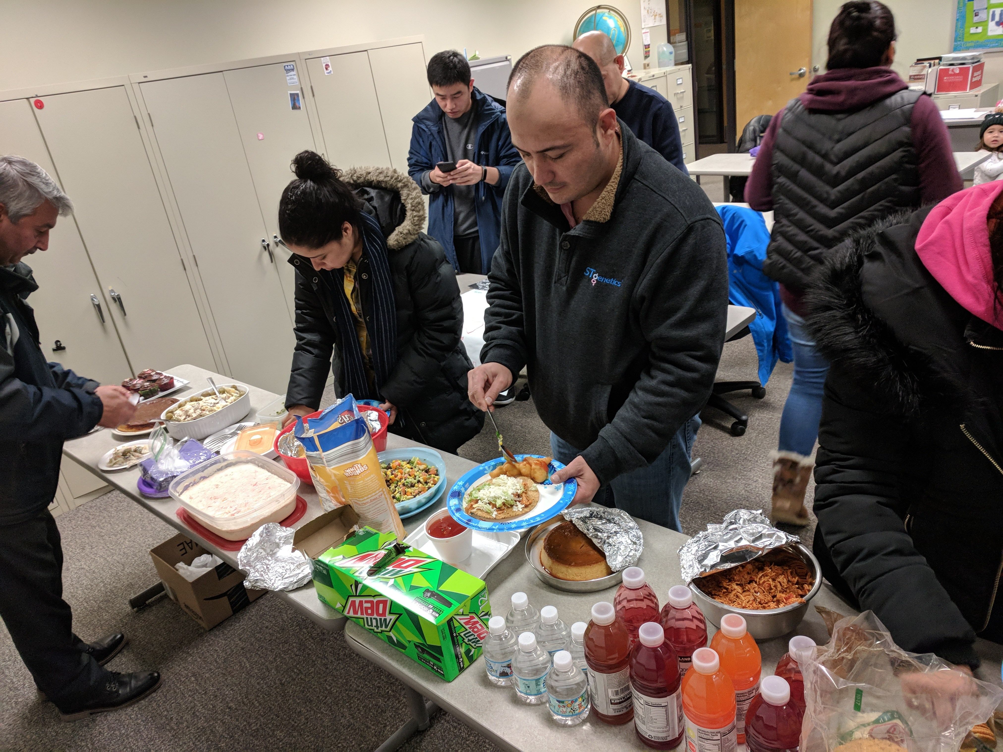people going through snack line with food on table 