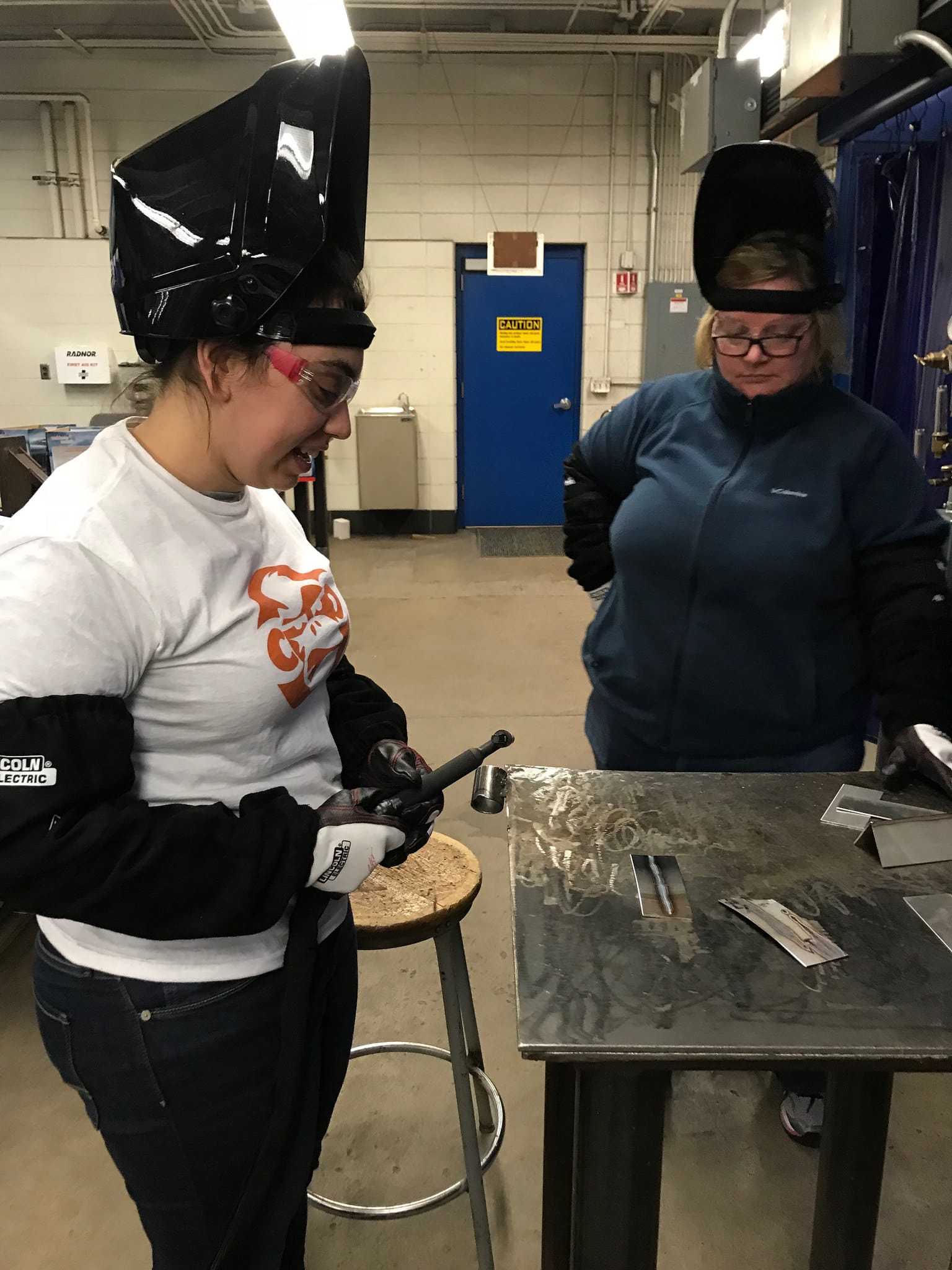 female students work on welding project