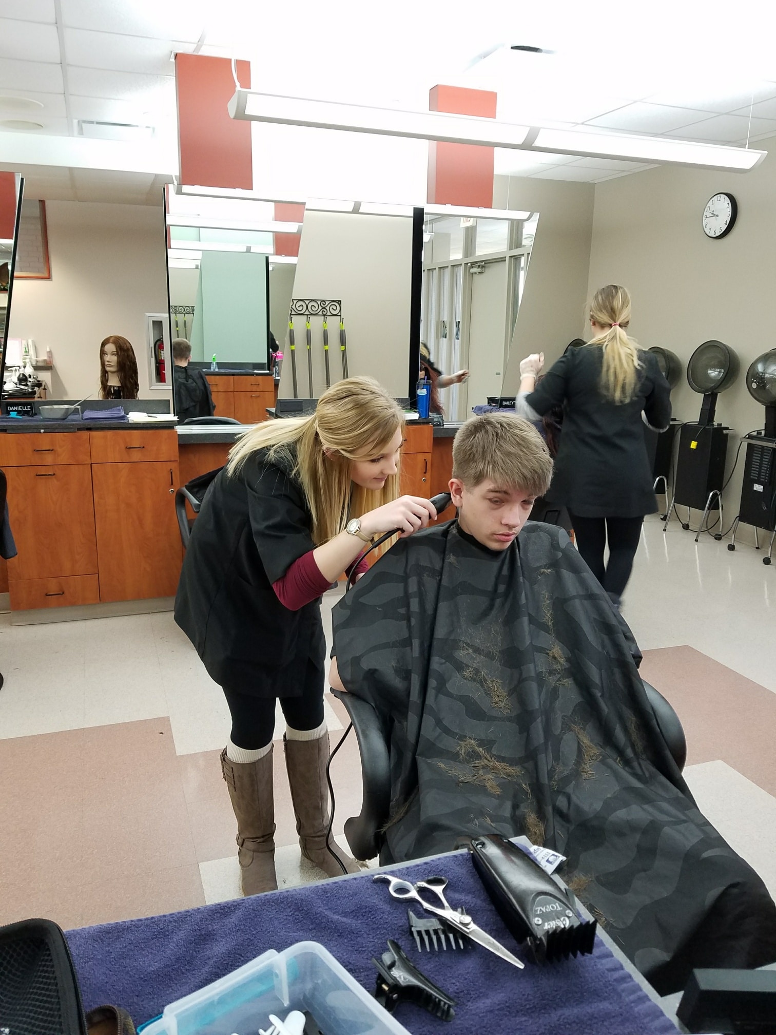 Cosmo student performing haircut on client